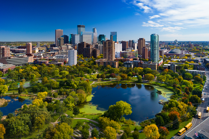 Minneapolis Skyline Aerial With Park And Lake exposing the tall eye-catching real estate buildings